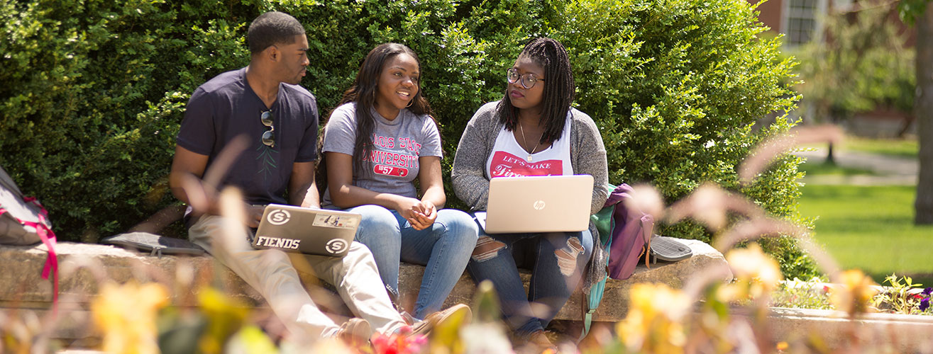 3 African American ISU Students Sitting Outside with Computers
