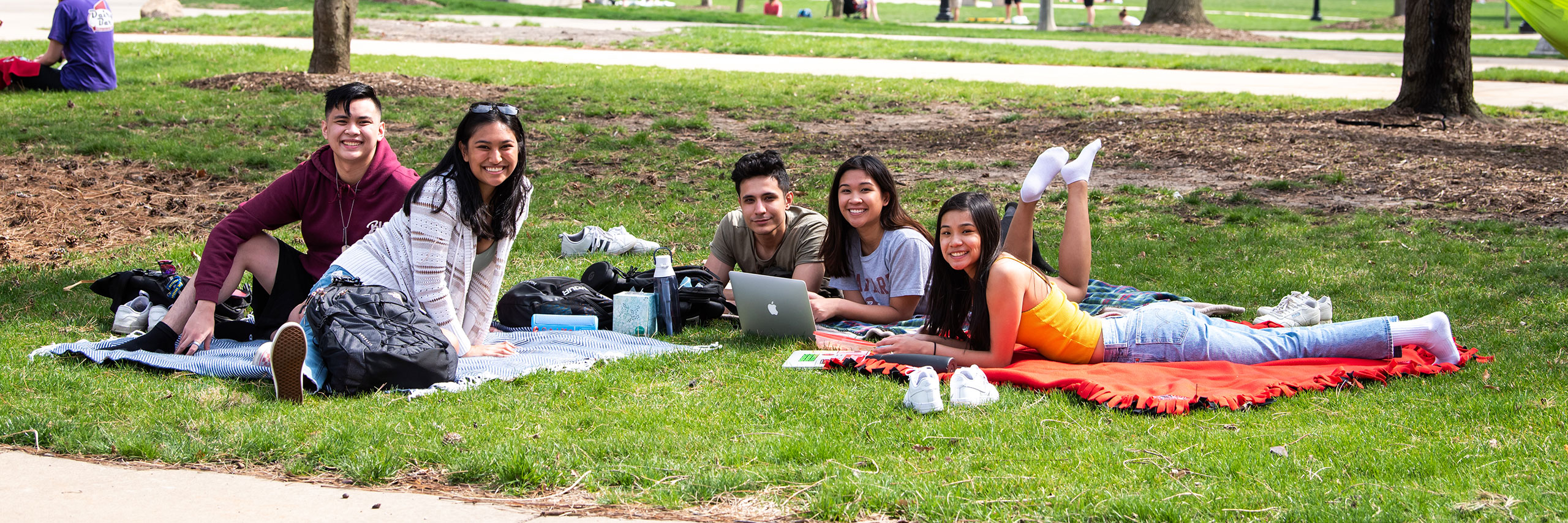 Group of ISU Students sitting outside.